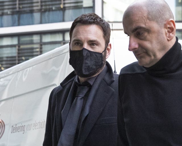 Song writer John “Johnny” McDaid (left) arrives at the Rolls Building