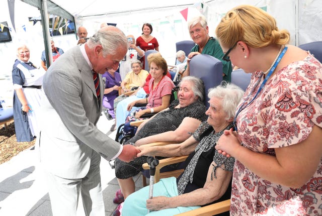 Charles meets patients sat the hospital