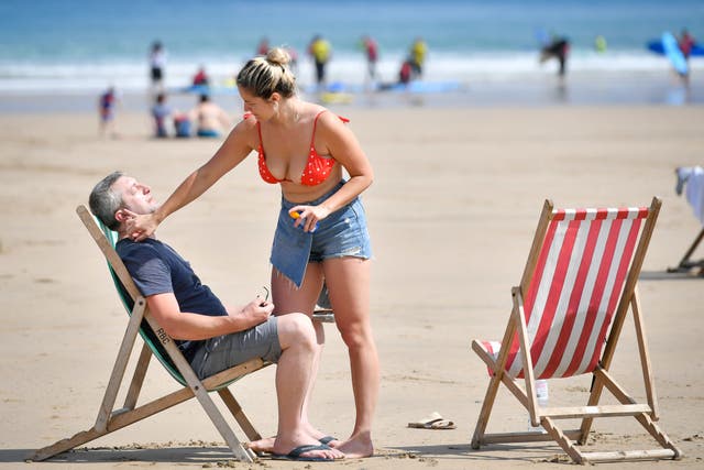 SSunbathers apply sunscreen
