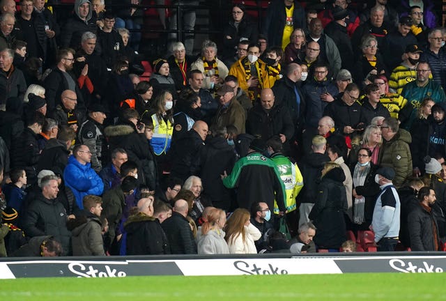 Medical staff attend to an issue in the crowd during the match