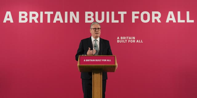 Sir Keir Starmer speaking from behind a lectern in front of letters spelling out 'A Britain built for all'