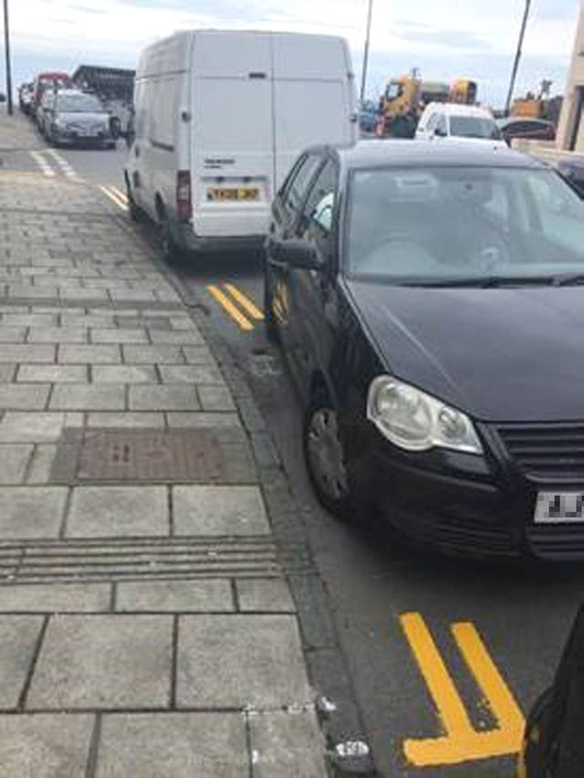 Yellow lines painted around cars