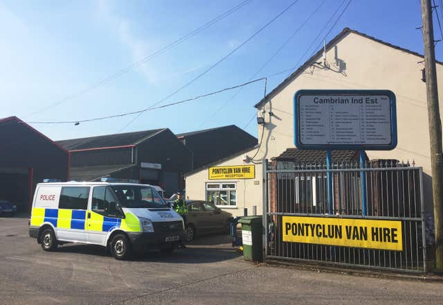 A police van outside Pontyclun Van Hire following the attack (Claire Hayhurst/PA)