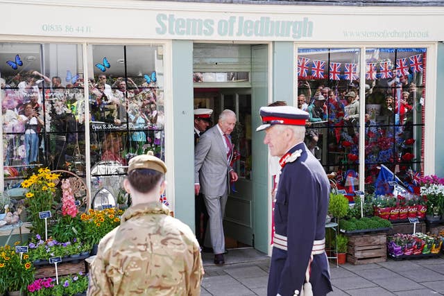 The King exiting a shop