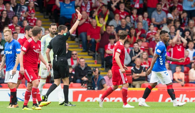 Morelos, pictured right, walks off after being shown a red card