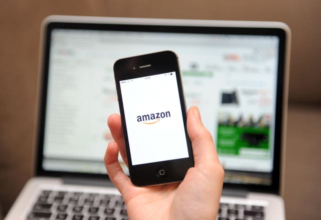 A woman uses a smartphone to browse the Amazon website