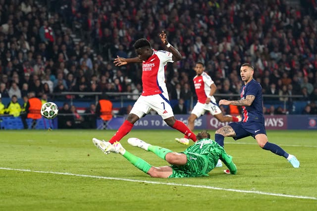 Bukayo Saka (centre) attempts a shot which goes over the bar