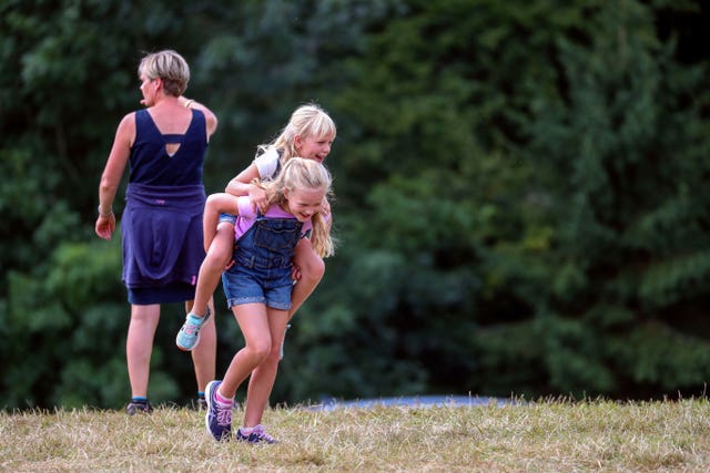 Savannah gives her sister Isla a piggy back