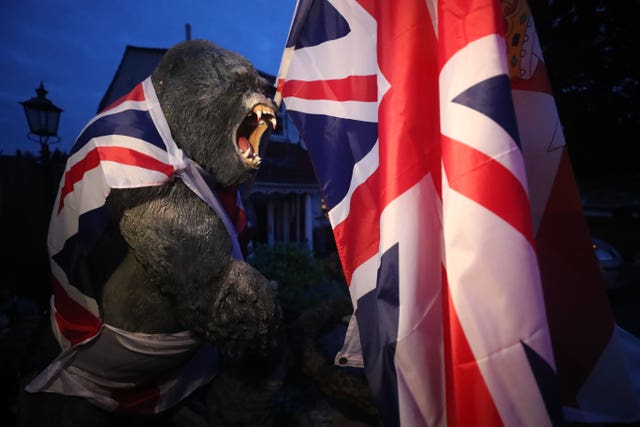 A plastic gorilla is wrapped in Union flag by a bonfire on Belfast’s Shankill Road 