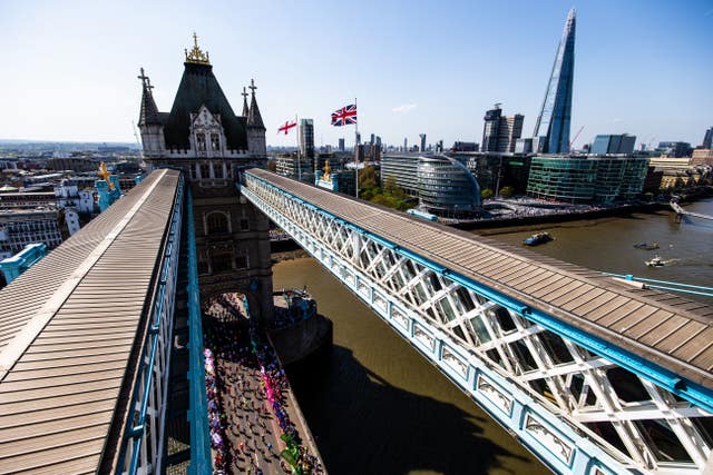 Runners make their way over Tower Bridge during a baking hot 2018 London Marathon