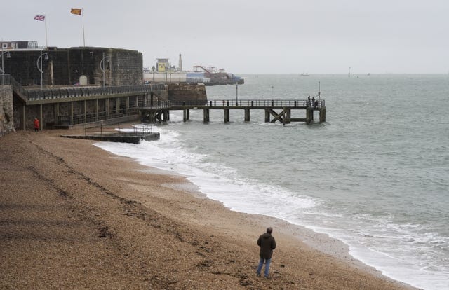 People walking along Hot Walls beach in Portsmouth
