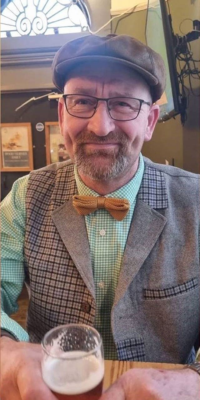 Dave Chester smiles while holding a pint