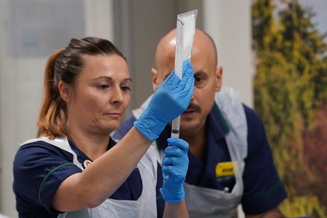 Senior clinical practice facilitators Nicole Prescott and Rob McDonnell prepare to administer a breakthrough CAR T infusion treatment for lupus to patient Katie Tinkler