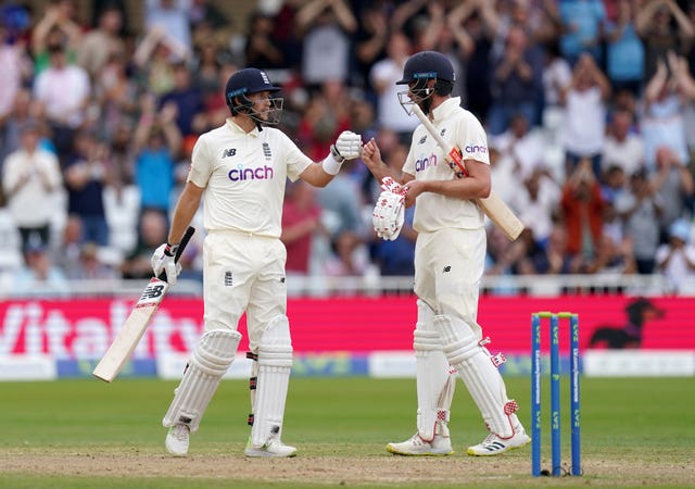 England’s Joe Root celebrates his 50 with team-mate Dom Sibley