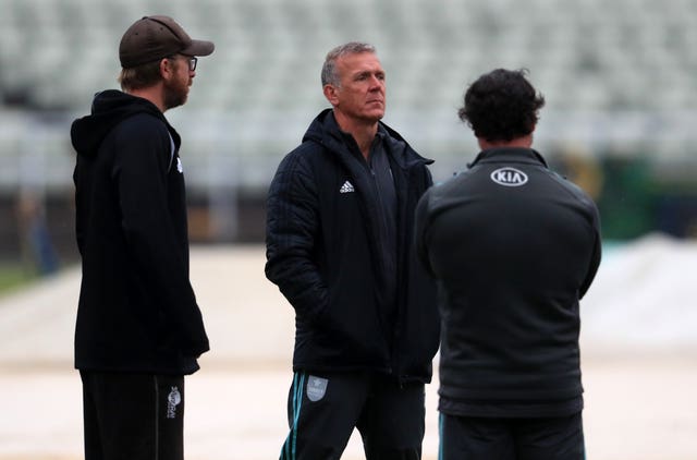 Surrey's director of cricket Alec Stewart assesses the sodden outfield.