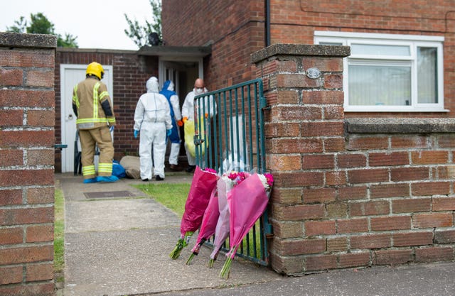 Floral tributes outside a flat on Oxford Avenue in Gorleston-on-Sea, Norfolk after the bodies of a man and a woman were discovered in the property