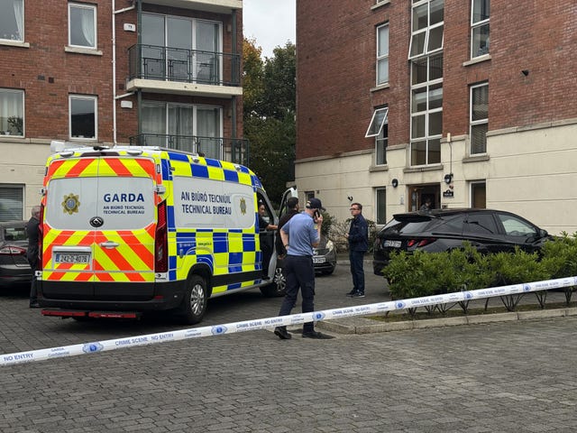 Garda vehicle and tape outside a building