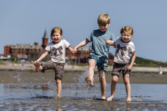 From left, Kara, Conor, and Katie McLaughlin on Newcastle beach in Co Down