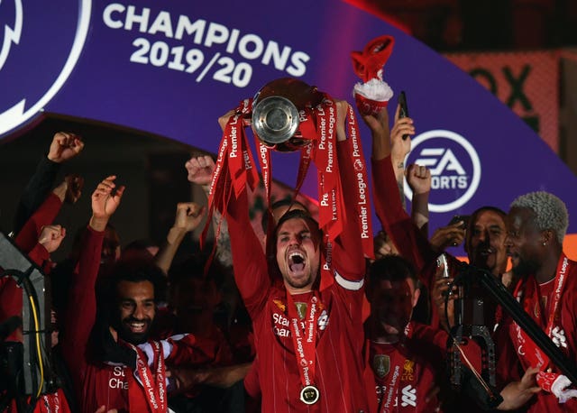 Jordan Henderson holds aloft the Premier League trophy