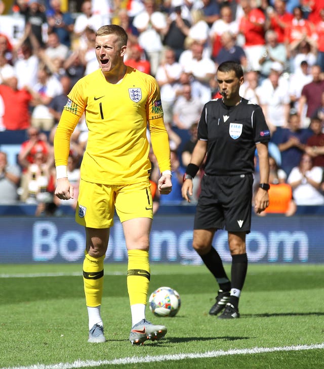 Jordan Pickford celebrates scoring a penalty in a Nations League third-place play-off shootout against Switzerland