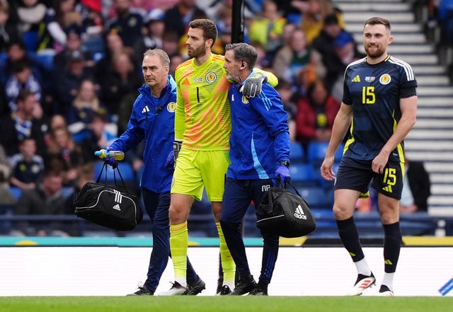 Scotland goalkeeper Angus Gunn (centre) leaves the Hampden pitch