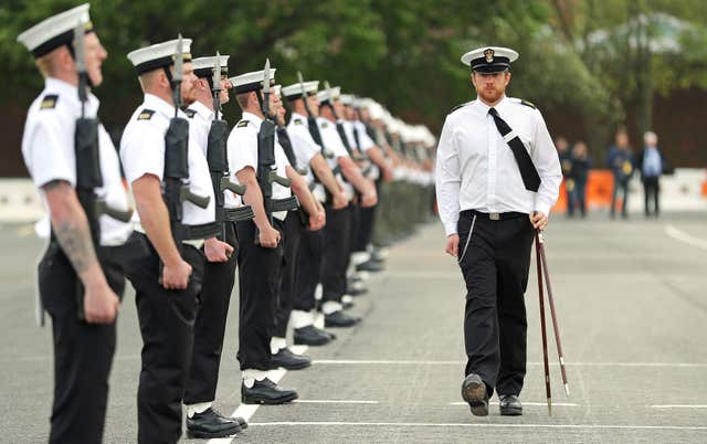 A Royal Navy Petty Officer measures the distances between members of the unit (Andrew Matthews/PA) 
