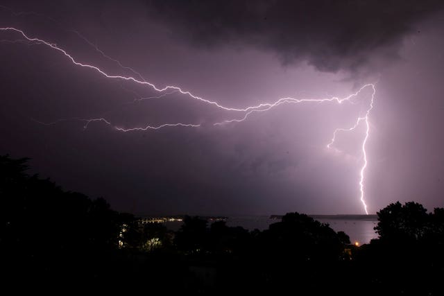 Lightning strikes over the Purbeck Hills beyond Poole harbour in Dorset (Martin Keene/PA)