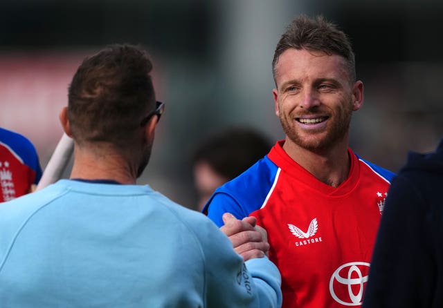 Brendon McCullum (left) shakes hands with Jos Buttler (right).