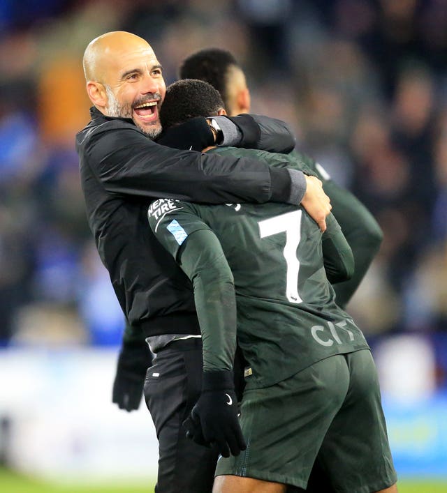 Pep Guardiola celebrates with Raheem Sterling, right, after the forward's late winner against Huddersfield last season