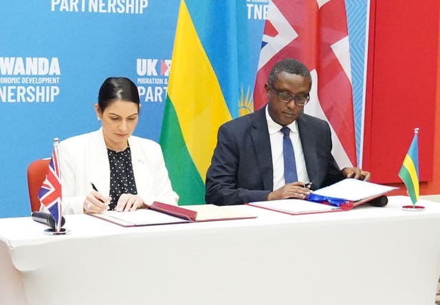 Priti Patel and Rwandan foreign minister Vincent Biruta, sign an agreement for asylum seekers to be processed in the east African country