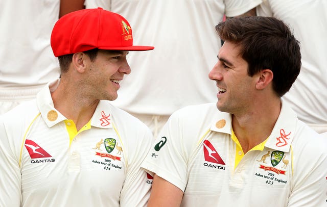 Australia’s Tim Paine, left, wearing the red cap which will be worn on day two