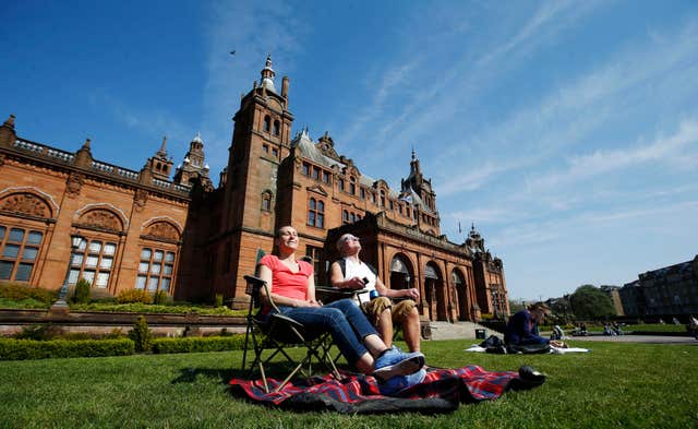 People enjoying the sun outside Kelvingrove Art Gallery and Museum in Glasgow (Danny Lawson/PA)