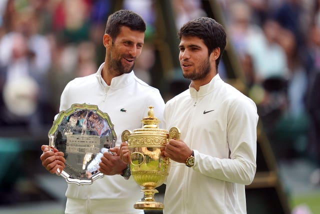 Carlos Alcaraz, right, with his Wimbledon trophy alongside runner-up Novak Djokovic