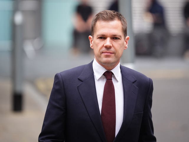 Head and shoulders photo of Robert Jenrick walking outside