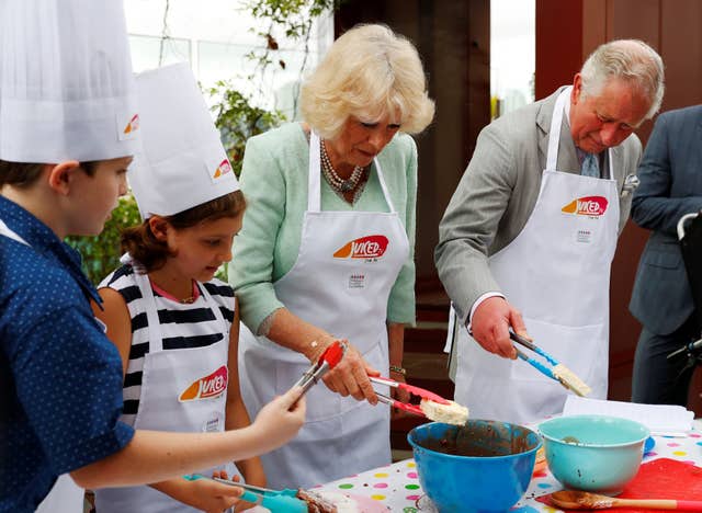 Camilla and Charles donned aprons to take part in a cooking activity at the hospital (Phil Noble/PA)