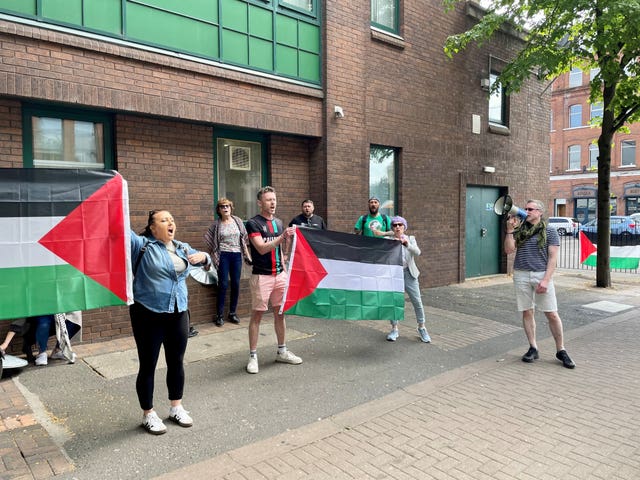 Protesters hold flags during a pro-Palestine demonstration outside BBC Blackstaff Studios in Belfast