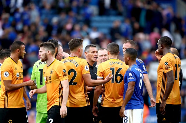 Wolves surround referee Andre Marriner at the end of the match after VAR ruled out a goal against Leicester