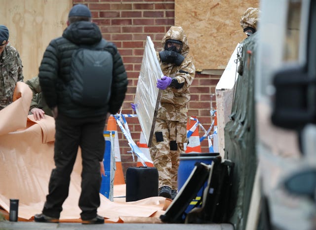 A window is removed by a member of the military as work continues on the home of former Russian spy Sergei Skripal in Salisbury, Wiltshire (Andrew Matthews/PA)