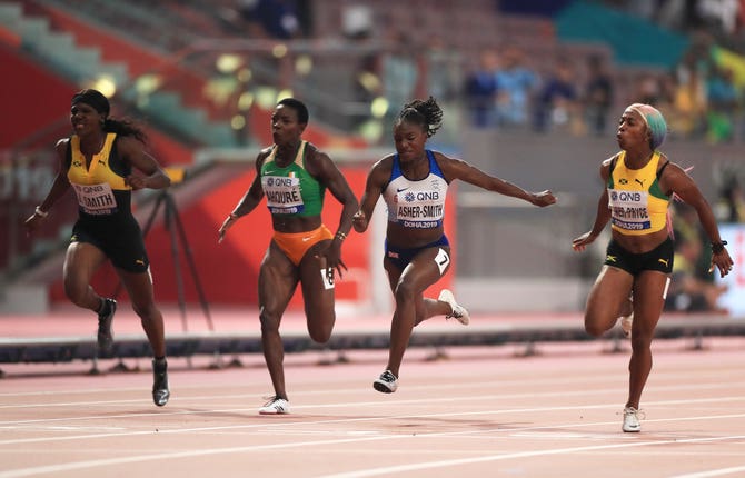 Shelly-Ann Fraser-Pryce, far right, came out on top as Asher-Smith, second right, became the first British female sprinter to claim a world medal