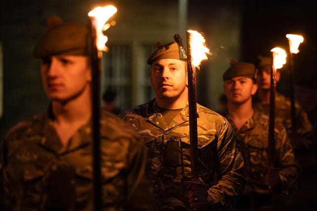 Soldiers holding torches