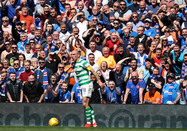 Rangers fans cheer towards Celtic's Scott Brown as the blue half of Glasgow enjoys an Old Firm derby victory