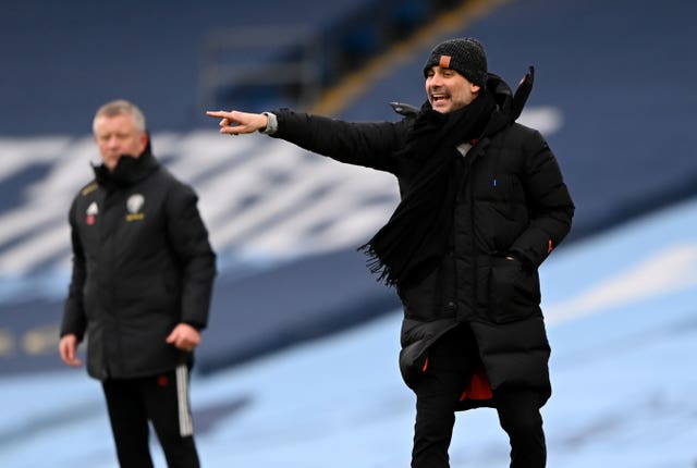 Manchester City manager Pep Guardiola, right, and Sheffield United boss Chris Wilder