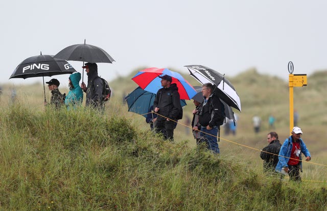 Crowds shelter from the rain during day two of The Open Championship 2019 at Royal Portrush Golf Club