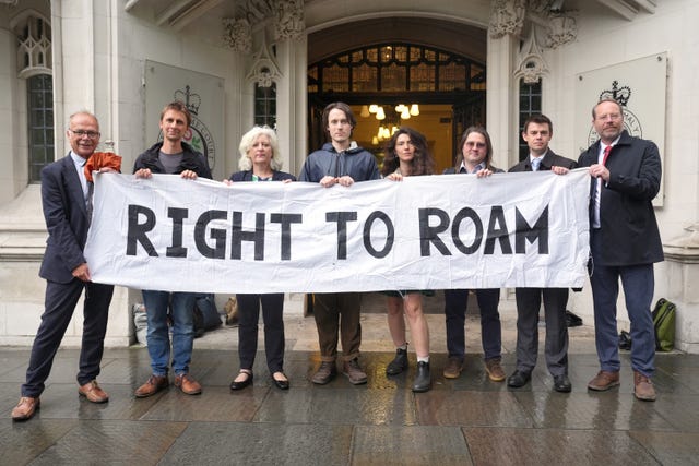 MPs and campaigners holding a banner outside the Supreme Court that says 'Right to Roam'