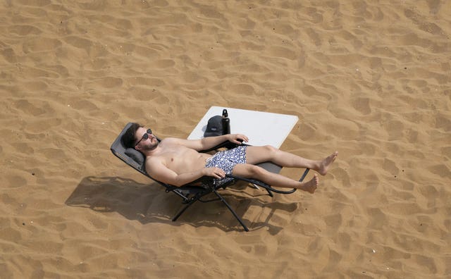 A man relaxes on the beach in Broadstairs, Kent