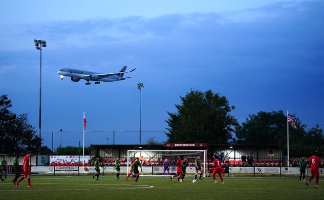 A aeroplane flies past the pitch during Hounslow United's FA Cup qualifying clash with Banstead Athletic. The match – which ended in an emphatic 6-1 success for Hounslow – was played at Bedfont Sports Club, which is adjacent to Heathrow Airport.