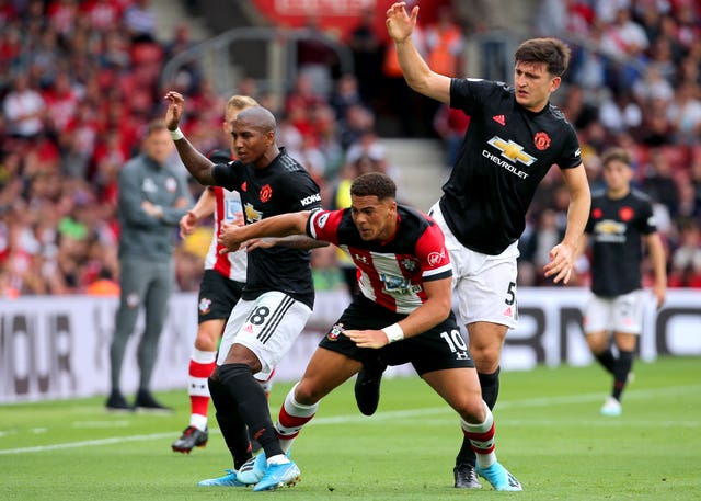 Southampton's Che Adams (centre) clashes with Ashley Young (left) and Maguire