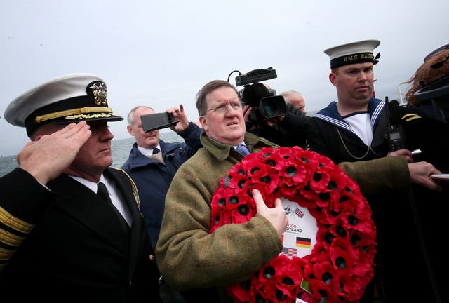 Lord George Robertson holds a wreath prior to the ceremony (Jane Barlow/PA)