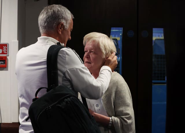 Mourinho speaks to a member of the Chelsea staff after the press conference