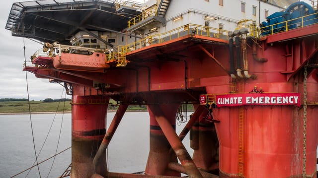 Banner and protesters on oil rig